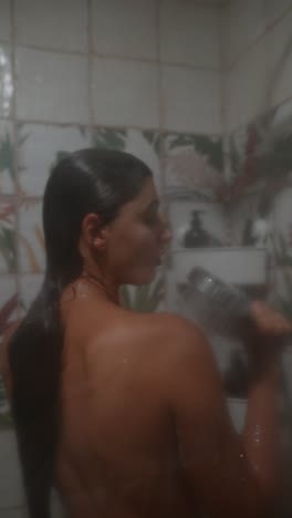 woman showering in a tiled bathroom