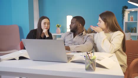 Group-of-friends-brainstorming-about-a-problem-on-laptop.