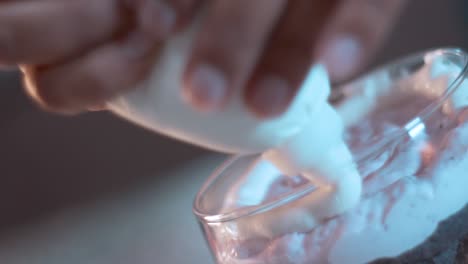 patry bag filling a cup with raspberry mousse