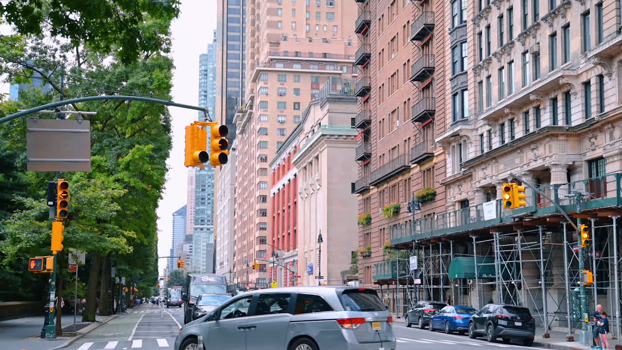 New York, USA, 4 August 2025: Traffic lights and skyscrapers in Midtown Manhattan. Intersection with bike lane and high‑rises near Central Park