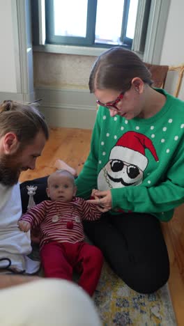 family enjoying time with a newborn during christmas