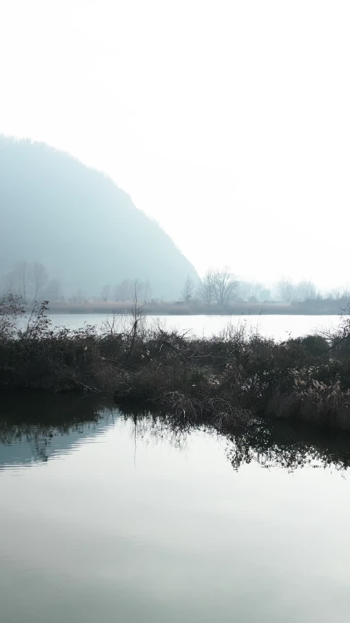A misty lake scene with mountains