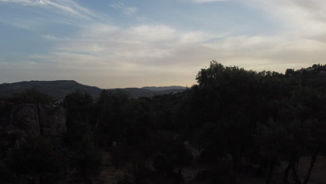 Rising-shot-of-the-Embalse-de-Santillana,-Sierra-de-Guadarrama-during-sunset