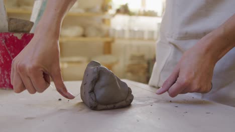 young female potter working in her studio