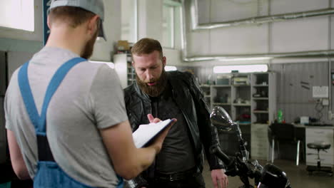 Mechanic-and-rider-talking-at-the-garage