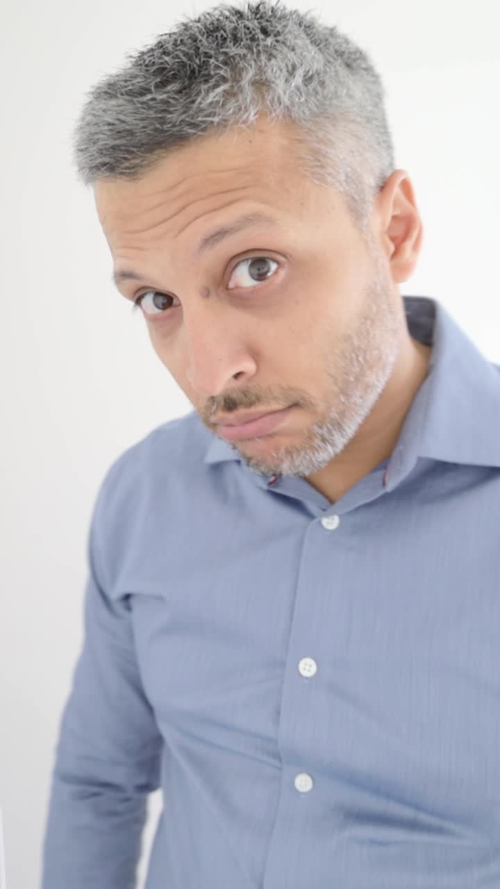 Curious Man with Gray Hair Looking Around and at Camera