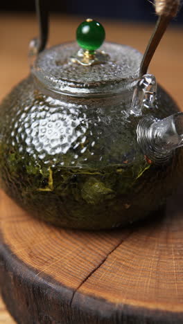 glass teapot with green tea