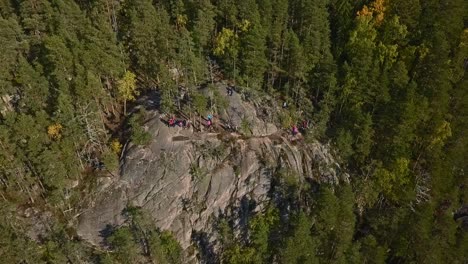 mountain in a forest, national park of finland, people and tourists at the peak