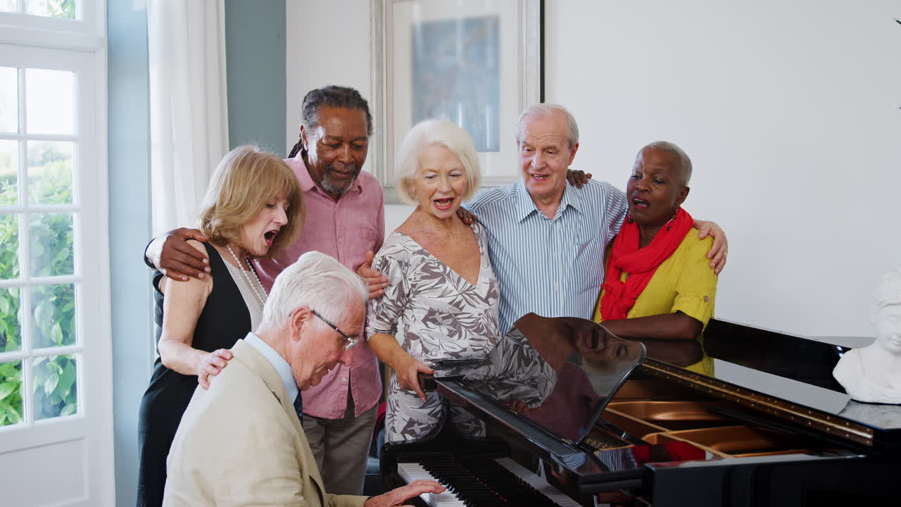 Group Of Seniors Standing By Piano And Singing Together