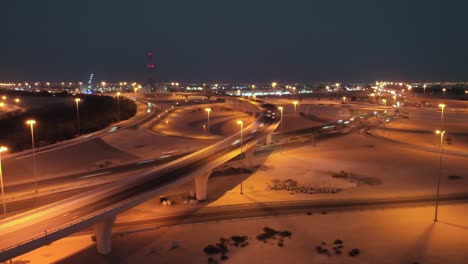 motion blurred cars driving on busy freeway overpass in abu dhabi at night