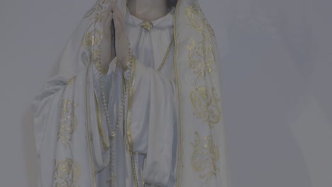 camera pans along a statue of mother mary