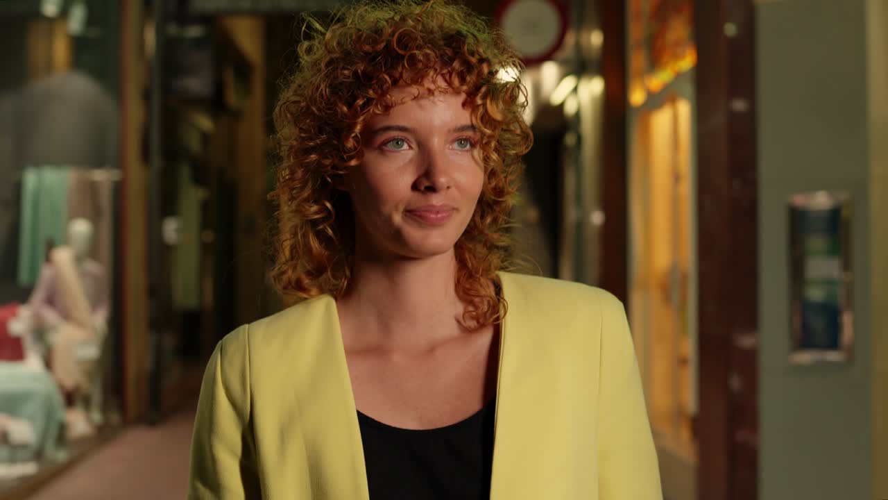 Woman in yellow blazer in a retail environment
