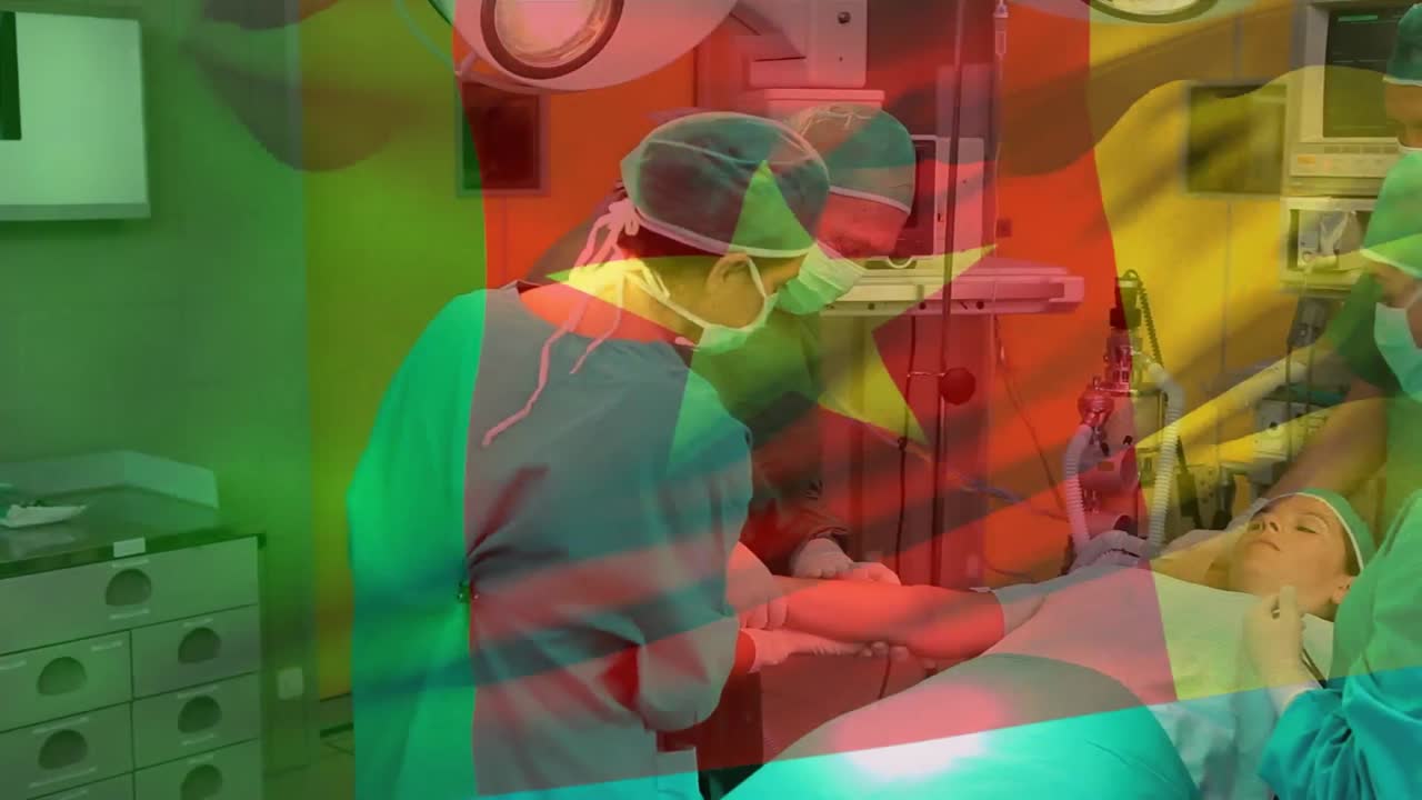 Animation of cameroon flag over diverse doctors examining hand of patient before surgery in hospital