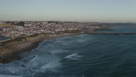 flying through the coastline of ericeira in sunset time