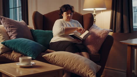 woman reading a book in a cozy living room