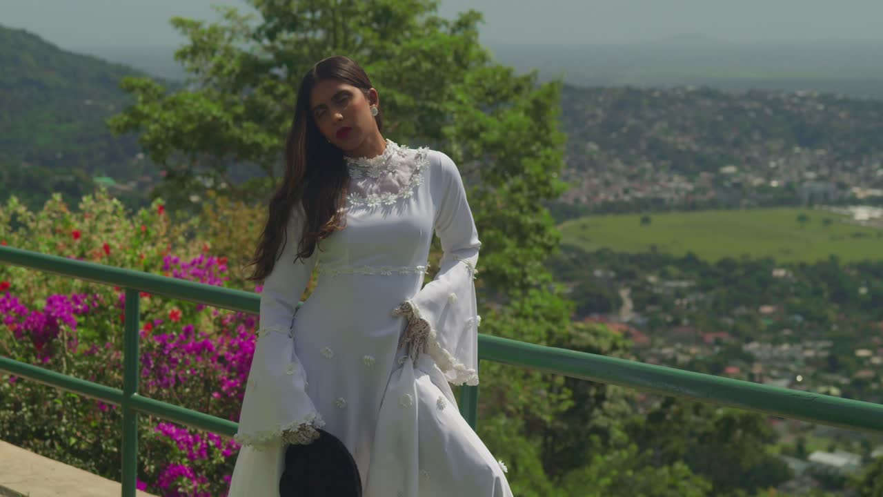 A girl in a timeless wedding gown wanders across an ancient fort.