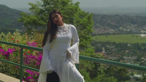 a girl in a timeless wedding gown wanders across an ancient fort.