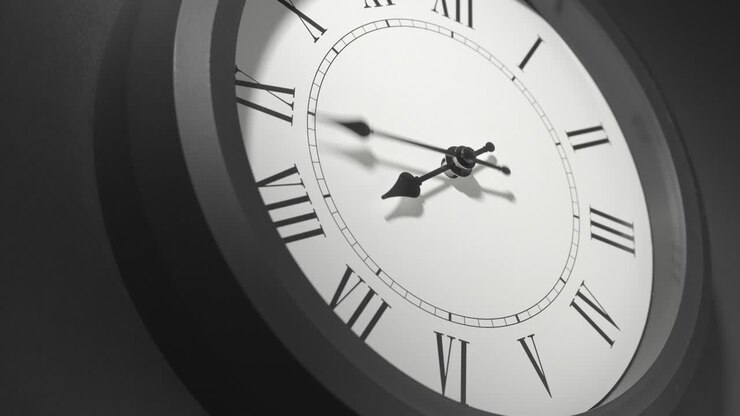 Latin Clock Face in Time Lapse on Dark Grey Wall
