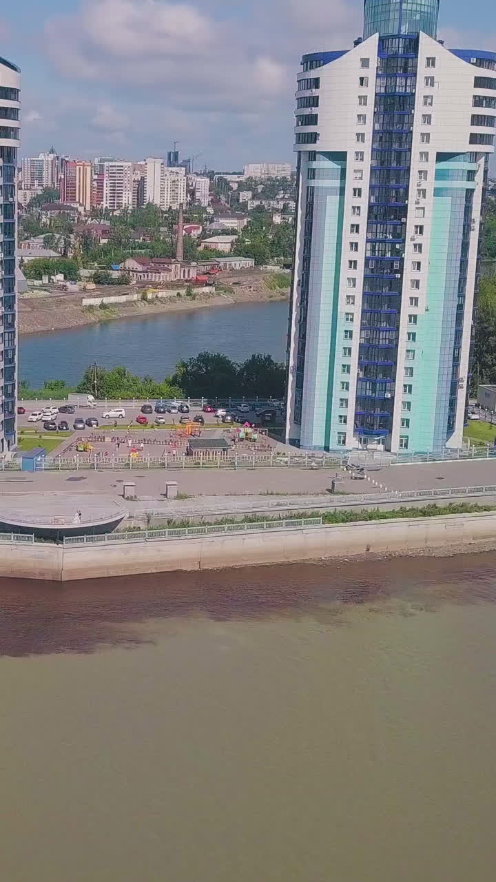 distant just married couple on waterfront in beautiful modern city on nice sunny day aerial view
