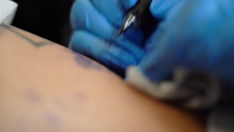 the tattoo artist is making a tattoo on a person's skin