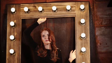 woman in a black dress with red hair