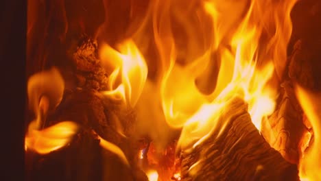 a captivating display of flames and burning wood: the dance of fire in a cozy fireplace setting