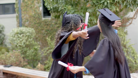 graduates celebrate their achievement outdoors