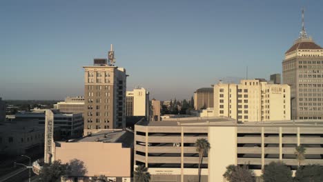 urban-cityscape,-close-up-downtown-buildings-long-pan-right-during-sunset