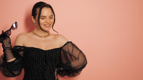 woman in a stylish black polka dot dress