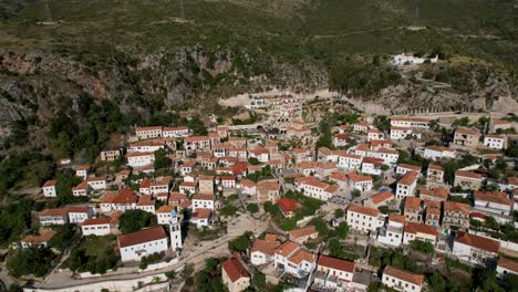 pueblo panorámico en la ladera de una colina: casas de piedra, resort de la riviera y escapada en airbnb en dharmi, albania