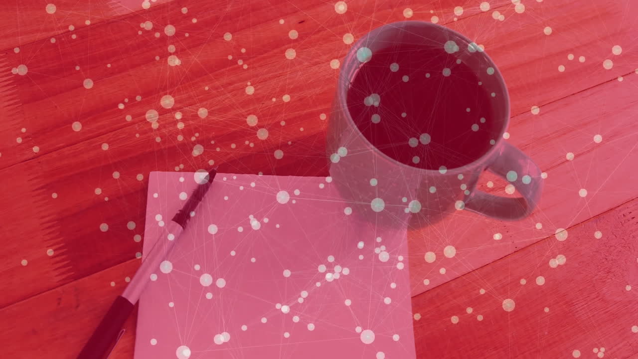 Digital network overlay being visualized on wooden tabletop scene, featuring coffee mug, pen, paper