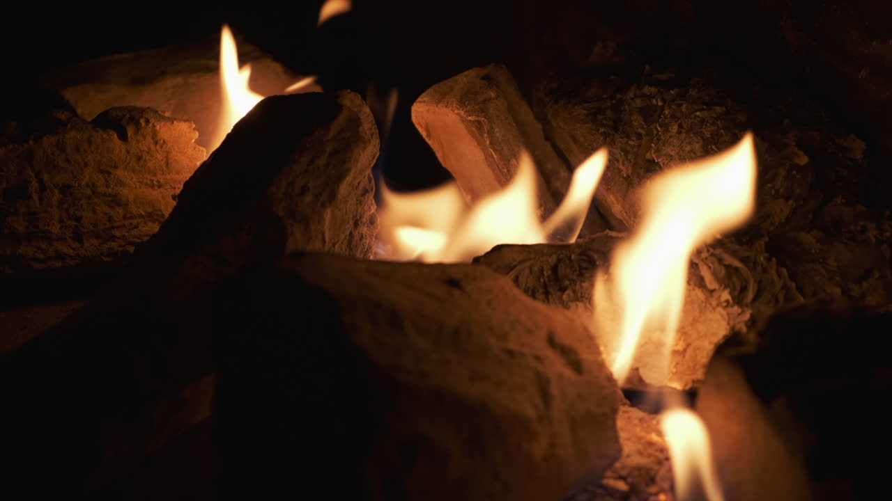 Fireplace. Fire. Dark in slow motion.