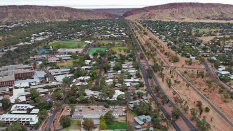 Static aeral view over Alice Springs, looking south towards the MacDonnell Ranges and Heavitree Gap, Alice Springs, Mparntwe, Northern Territory, Australia. August 2022.