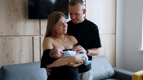 happy caucasian couple with a newborn in the hospital. couple in the maternity ward after childbirth.