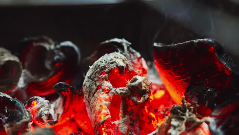 a close-up of burning coal, its vibrant embers radiating a hypnotic warmth against the backdrop of flickering flames