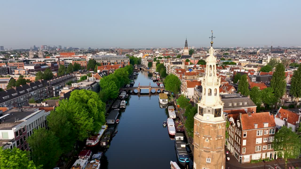 Drone footage of Montelbaanstoren, boats, and historic canal houses in Amsterdam