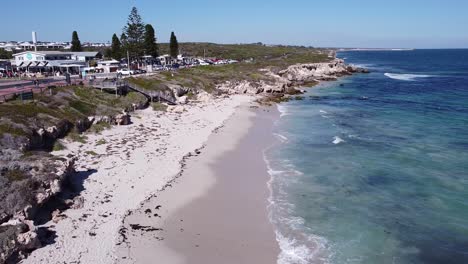 local cafe, white sandy beach and clear blue water of the indian ocean attract visitors