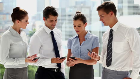 hombres de negocios comparando sus teléfonos inteligentes