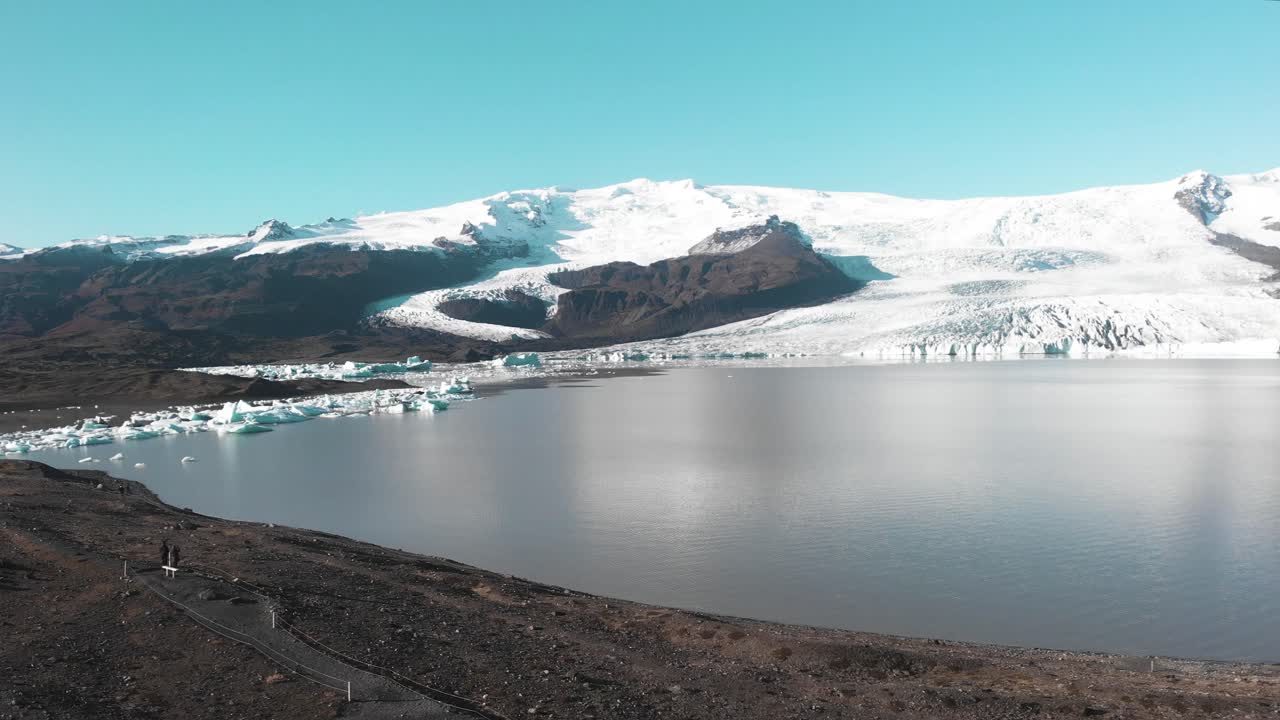 Fjalls&aacute;rl&oacute;n glacier lake in nordic Iceland landscape below snowy peaks
