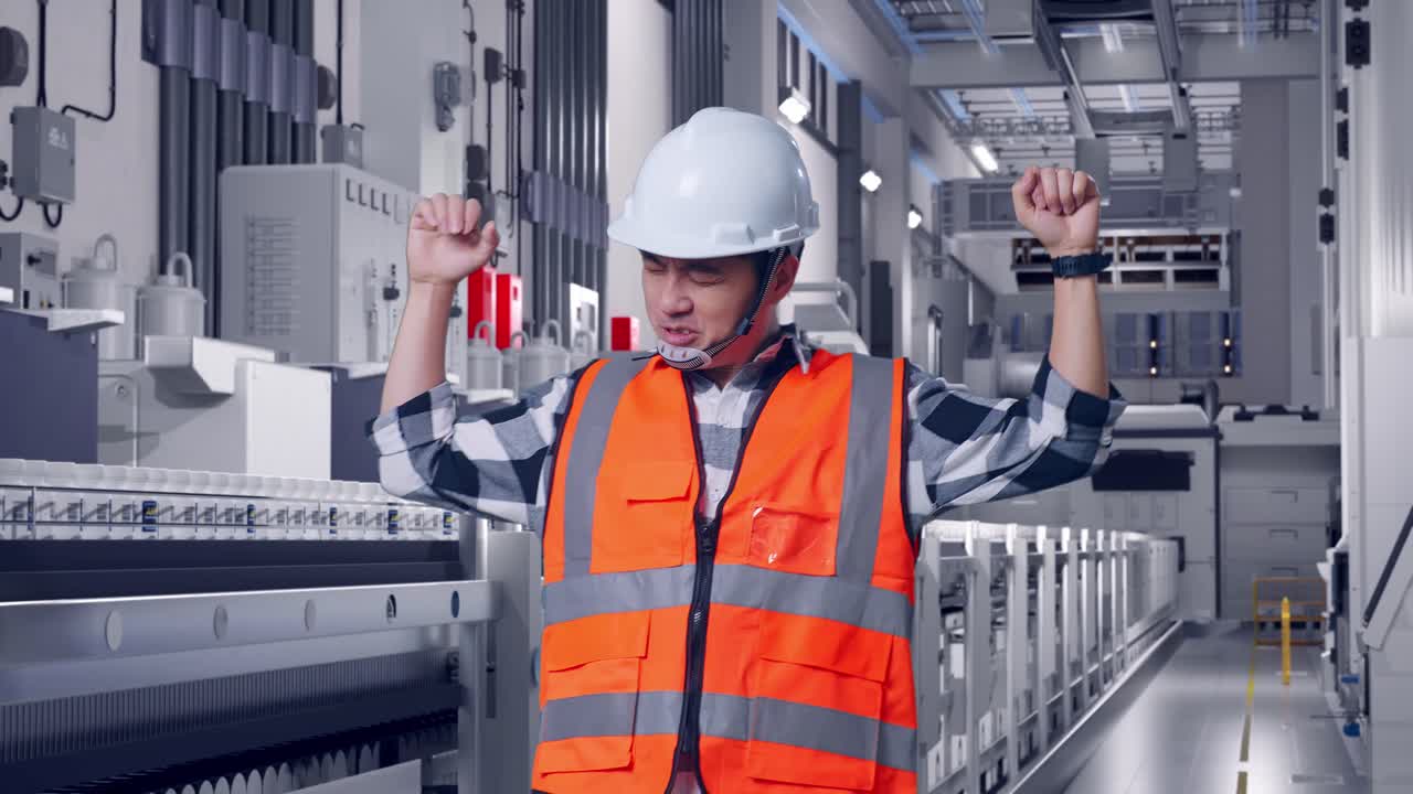 Asian Male Engineer With Safety Helmet Screaming Goal And Dancing Celebrating At Pharmaceutical Factory, Vaccine Production Facility