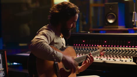 young artist songwriter composing a new song on guitar in recording session