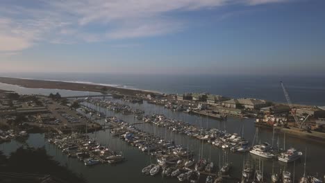 moss landing marina - california, usa. cinematic aerial dolly forwards with left rotational pan over yachts. filmed on dji mavic pro.