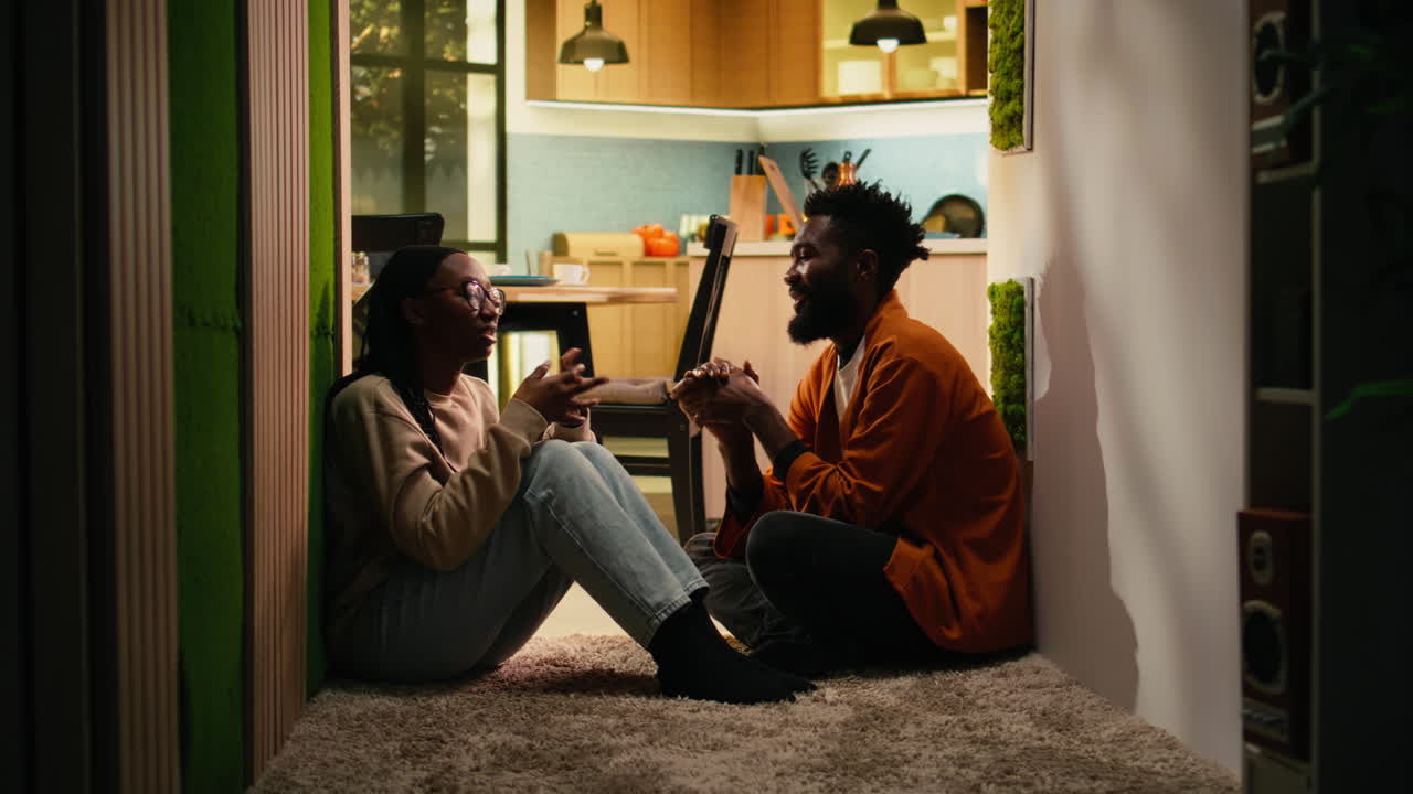 African American couple, solving problems, discussing in dark hallway