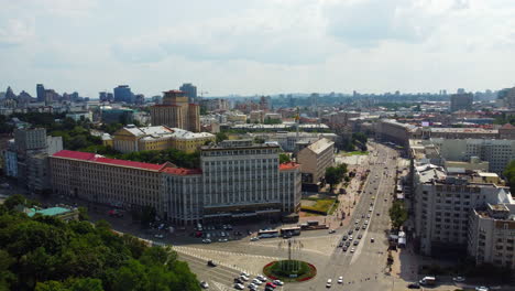 Flying-above-the-downtown-of-capital-of-Ukraine,-Kyiv,-over-European-Square-intersection-with-lots-of-traffic