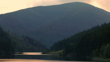 Zoom-in-Sance-drinking-water-reservoir-with-a-natural-valley-full-of-hills-and-mountains-around-the-water-level-which-moves-in-a-strong-wind