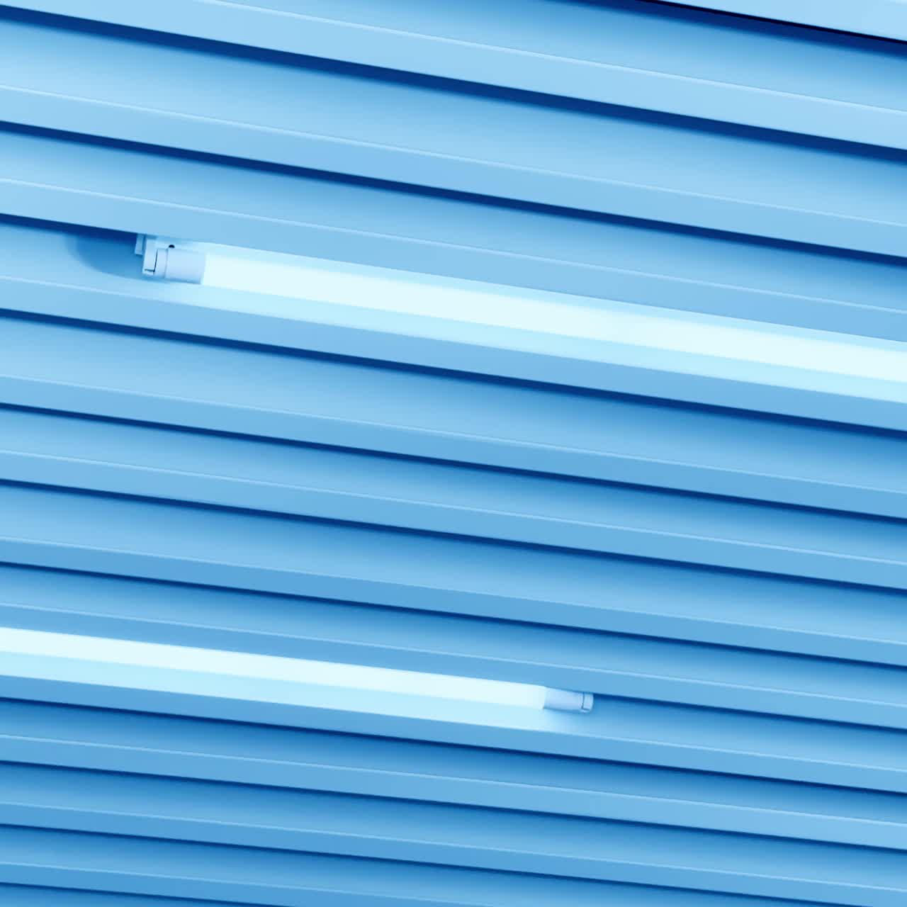 Switched on led lamps among the panels on the ceiling in diverse directions. View from below