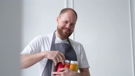 portrait of a smiling artist who dilutes paint before painting - a happy and smiling artist dilutes the paint to paint a picture. modern abstract oil painting