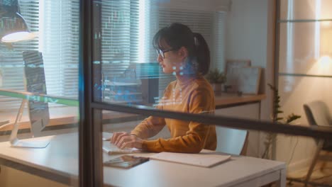 asian female stock market trader working in office at night