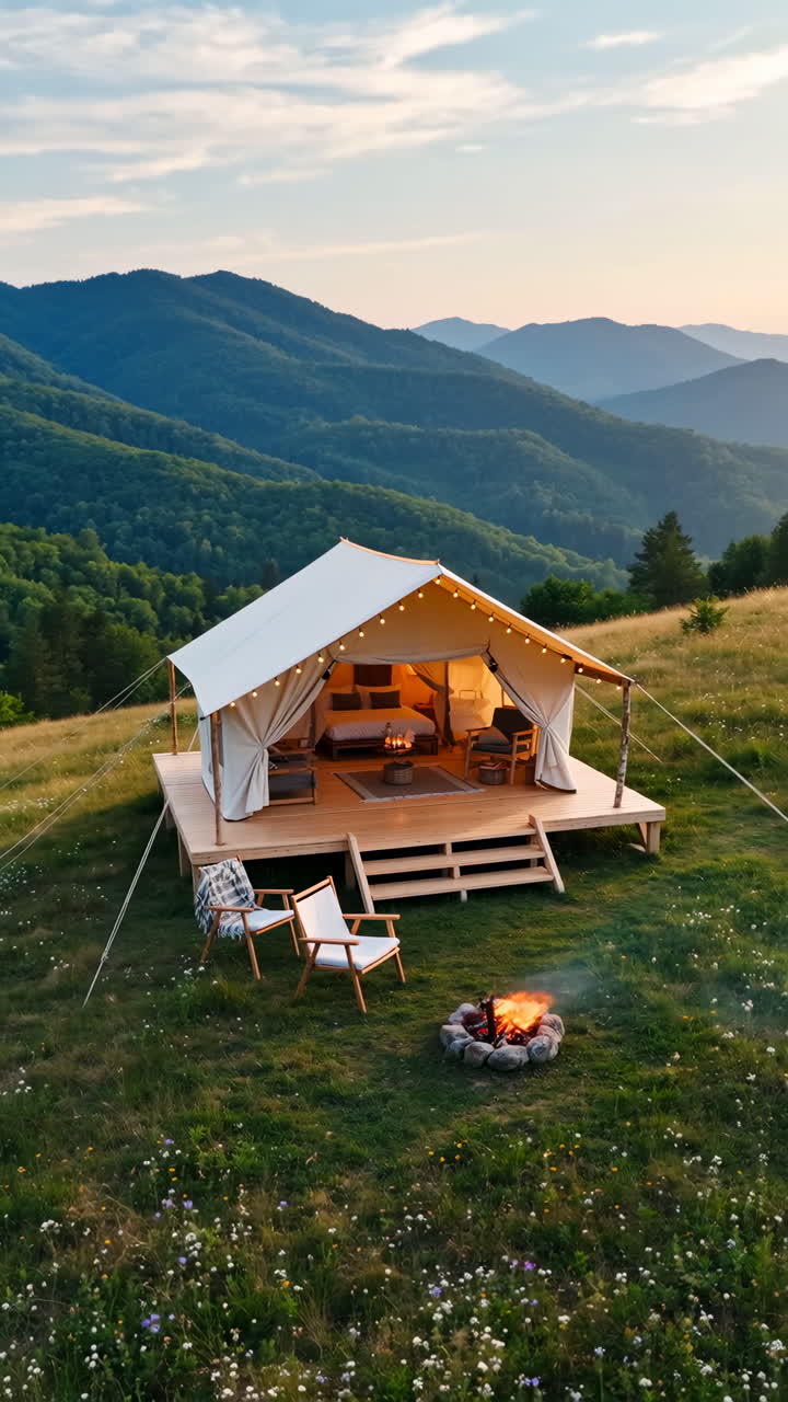 Luxurious Glamping Tent with Campfire in Mountain Landscape at Sunset