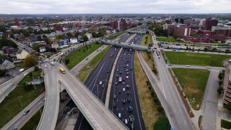 aerial of traffic on a highway going into a city